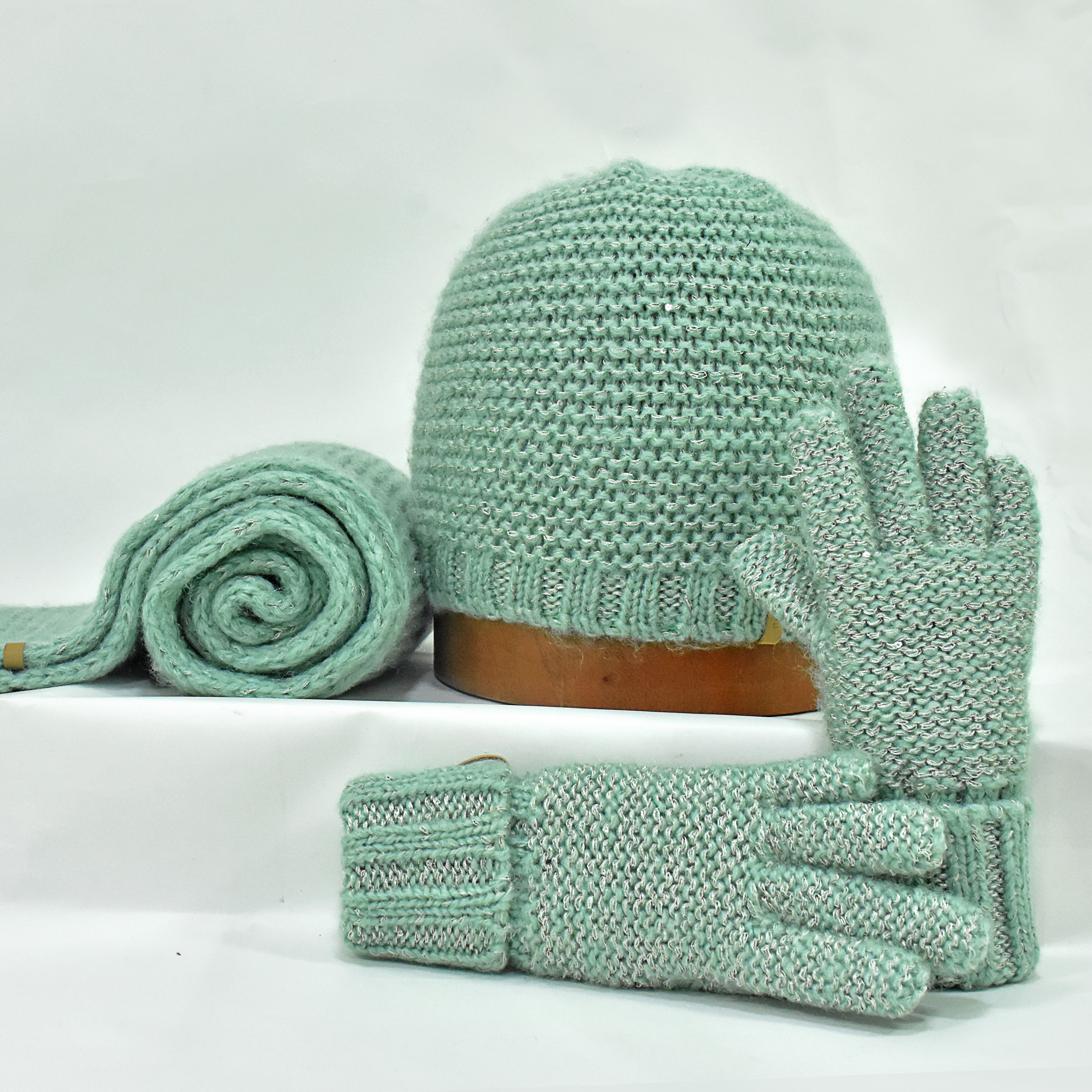 Green knitted gloves, mittens and beanie